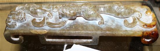 A Chinese green and russet jade archaistic sword slide, 12.9cm